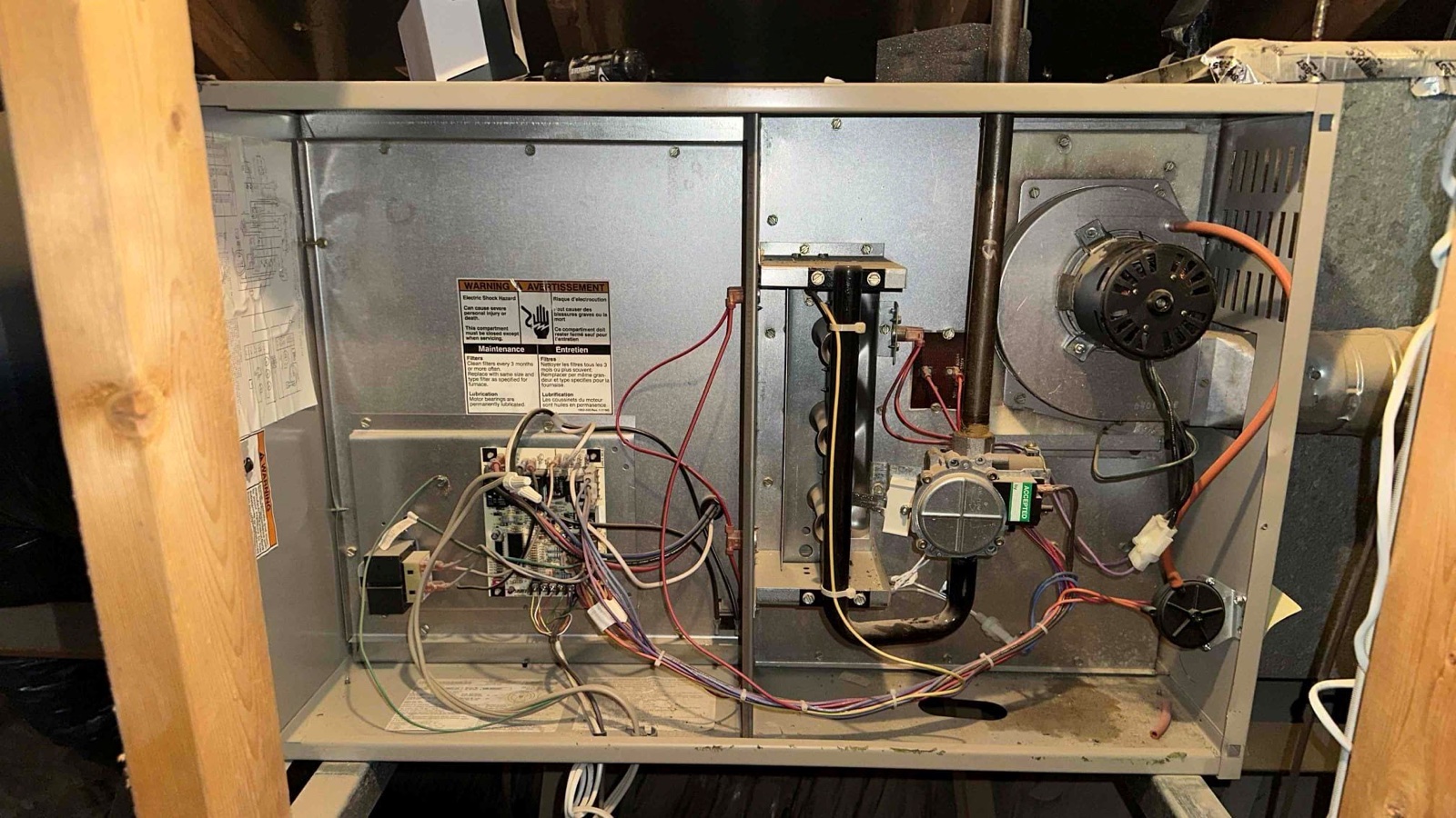 Open furnace cabinet showing the parts checked during heating service